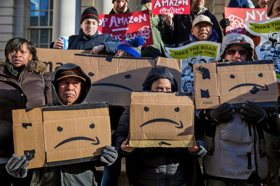 Anti-Amazon+protesters+gather+before+a+New+York+Council+meeting%2C+displaying+their+opposition+to+Amazon%27s+plans+for+a+headquarters+location+in+Long+Island+City.+Amazon+ultimately+scrapped+their+plans+for+the+Long+Island+City+headquarters+after+receiving+harsh+backlash+from+lawmakers%2C+progressive+activists%2C+and+members+of+the+local+community.%0A%28Credit%3A+Hiroko+Masuike%2FThe+New+York+Times%29