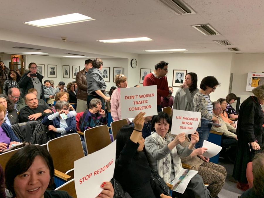Residents+express+their+frustration+with+the+proposed+changes+as+they+hold+up+signs+that+say+%22Stop+Rezoning%2C%22+%22Don%27t+Worsen+Traffic+Congestion%22+and+%22Use+Vacancies+Before+Building.%22+The+proposed+changes+would+permit+developers%2C+if+approved+by+the+Village+Board%2C+to+construct+buildings+of+four+or+five+stories.
