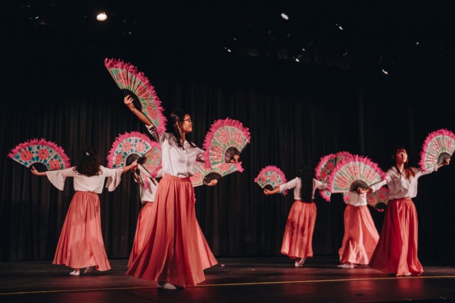 Performers dance using colorful fans in the Korean fan act. Performances like the Korean fan dance celebrate traditional aspects of Asian cultures in North High’s Asian Culture Night. (Credit: Joanna Chung)