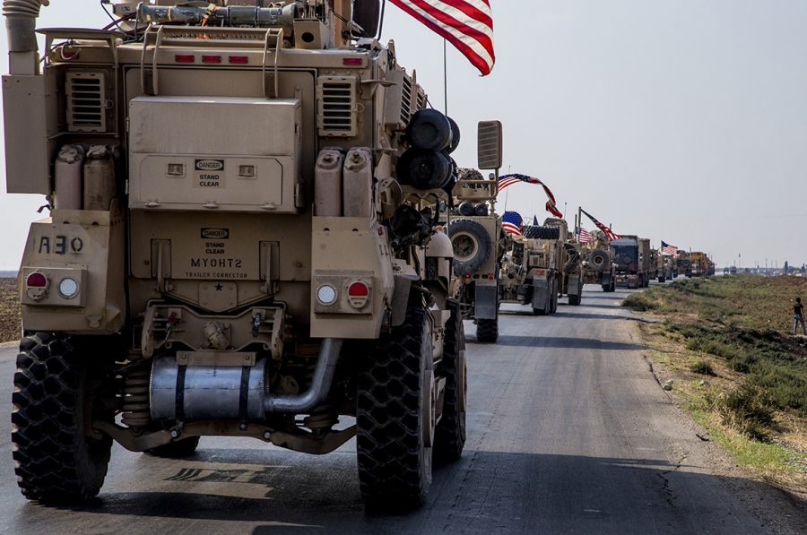 U.S.+military+convoys+drive+near+the+town+of+Qamishli+in+northern+Syria.+The+vehicles+head+south%2C+likely+heading+to+the+oil-rich+Deir+el-Zour+region+or+another+base+nearby+%28AP+Photo%2FBaderkhan+Ahmad%29.