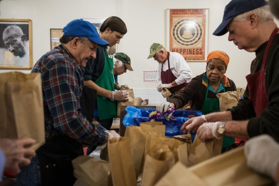 Volunteers preparing meals at a soup kitchen in Brooklyn. (Credit: Todd Heisler/The New York Times)