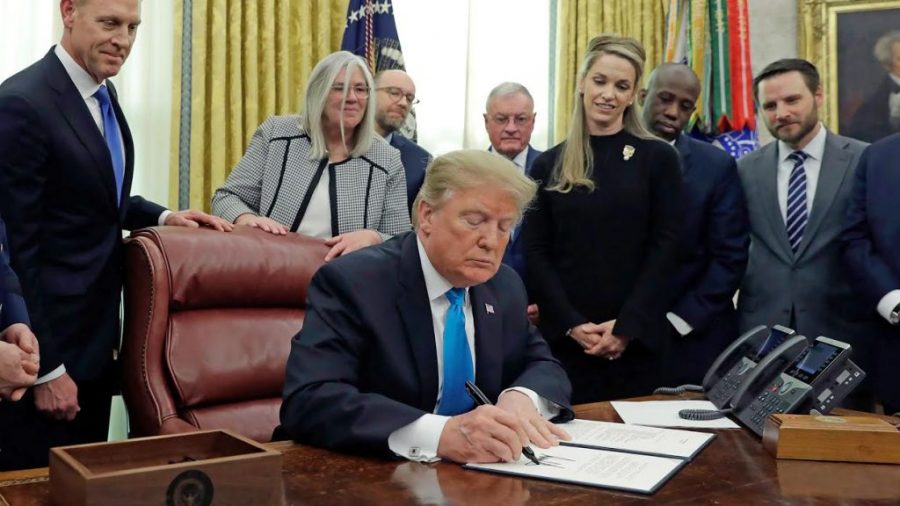 Trump signing the defense policy which brings existence to tue new US Space Force in the White House. Source: Pix11.com