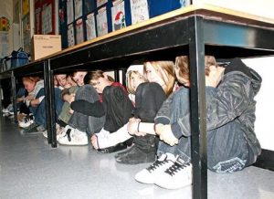 Students hiding under desks as part of a lockdown drill. (Photo credit: Ohio Education Association)