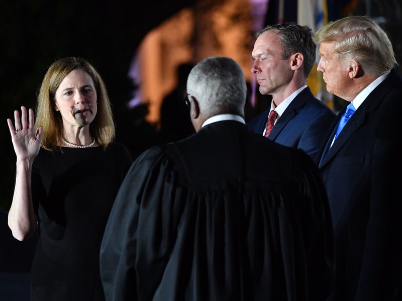 President Donald Trump and Jesse M. Barrett watch as Supreme Court Associate Justice Clarence Thomas swears in Amy Coney Barrett as a U.S. Supreme Court Associate Justice. (Credit: NPR)