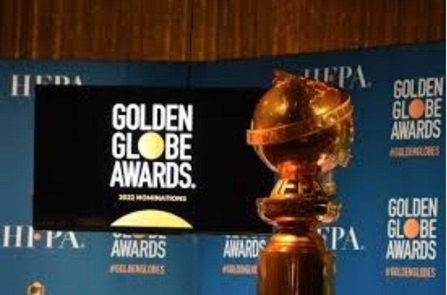 The Golden Globe Awards trophy lies in front of an image of the events logo. (credit: www.newsweek.com)