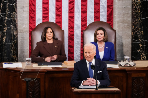 Joe Biden (middle), Kamala Harris (left), and Nancy Pelosi (right) sit as Biden delivers State of the Union.