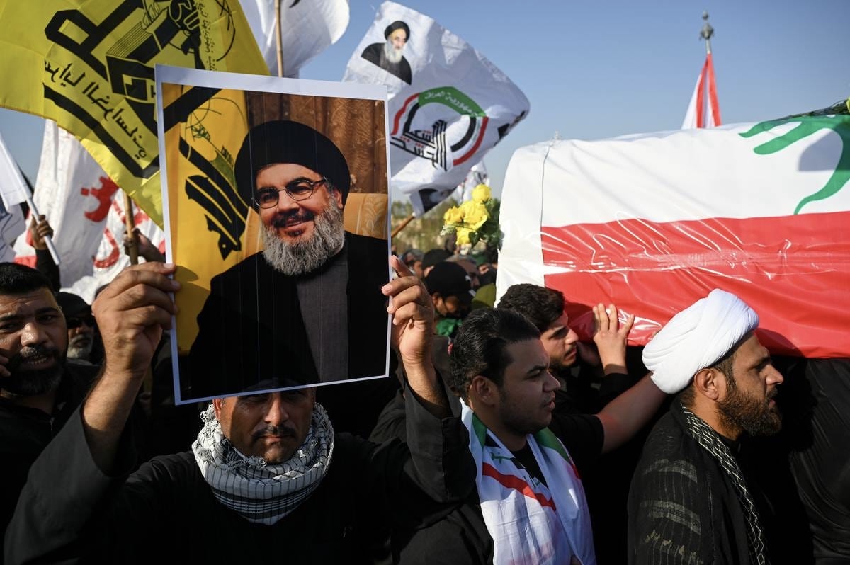 Hassan Nasrallah is seen on a giant screen giving a speech to his supporters during a rally in Beirut (Credit: The Liberum archive).
